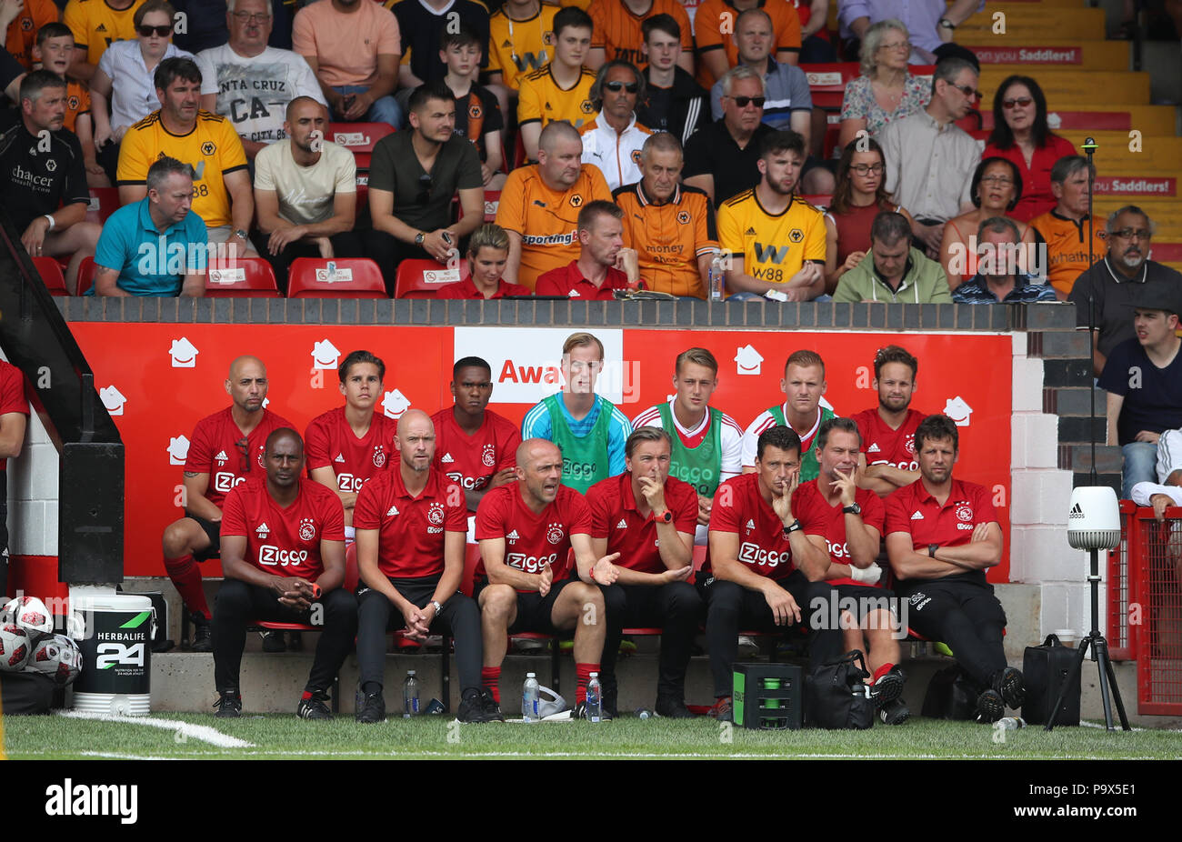 Ajax's Manager Erik ten Hag (front row, second left) with his coaching staff and Daley Blind on the bench (back row top right) during a pre season friendly match at the Banks's Stadium, Walsall. PRESS ASSOCIATION Photo. Picture date: Thursday July 19, 2018. Photo credit should read: Nick Potts/PA Wire. EDITORIAL USE ONLY No use with unauthorised audio, video, data, fixture lists, club/league logos or 'live' services. Online in-match use limited to 75 images, no video emulation. No use in betting, games or single club/league/player publications. Stock Photo