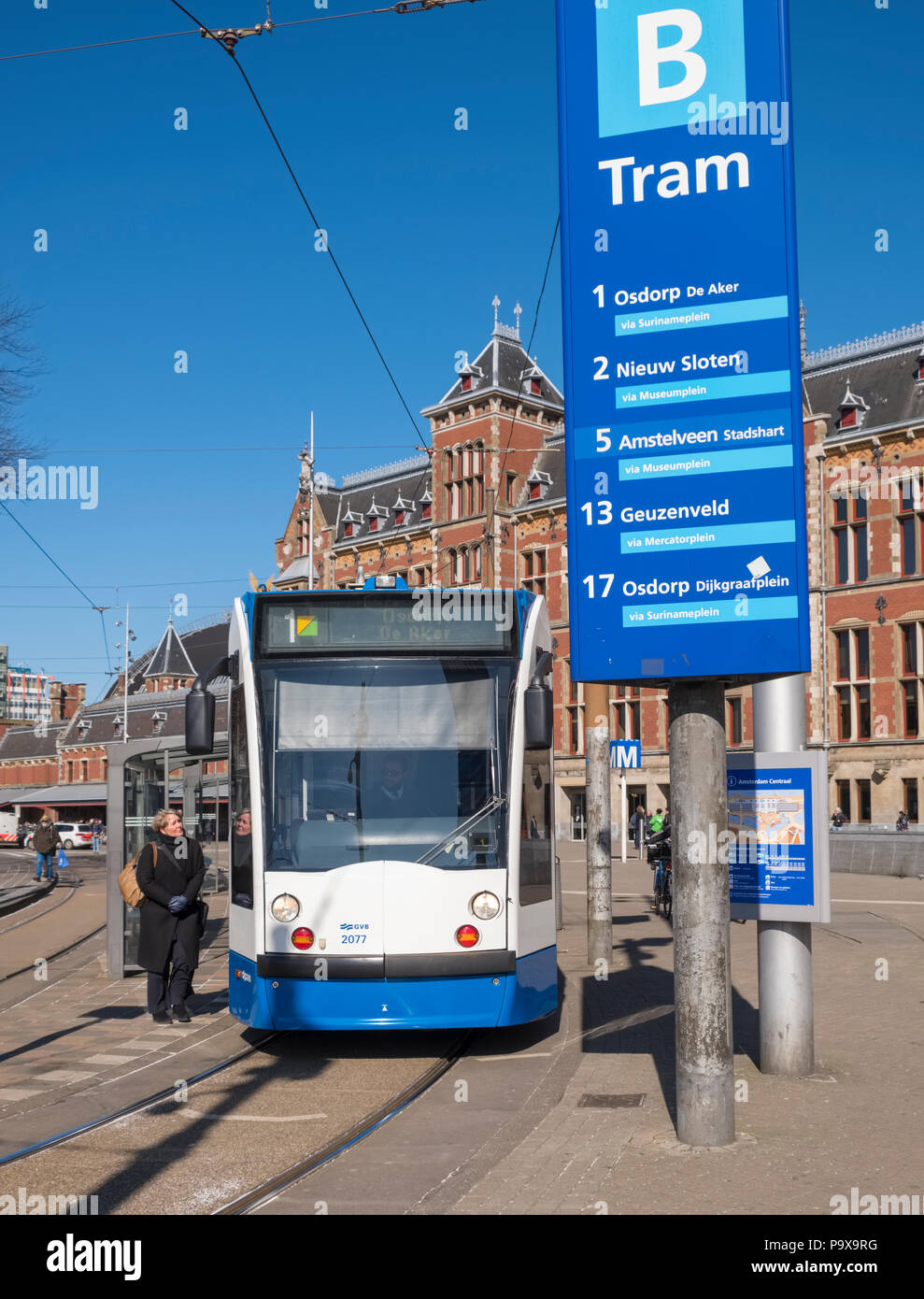 Tram streetcar at a tram stop outside Amsterdam Centraal Station, Amsterdam, Netherlands, Holland, Europe Stock Photo