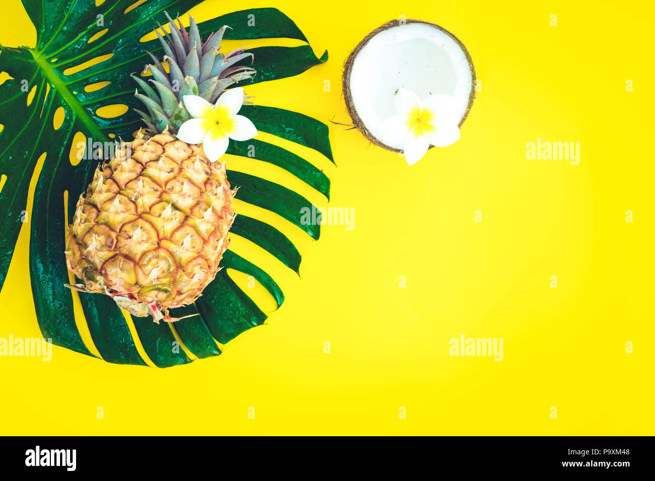 Summer flat lay scene with tropical green leaves, coco and pineapple ...