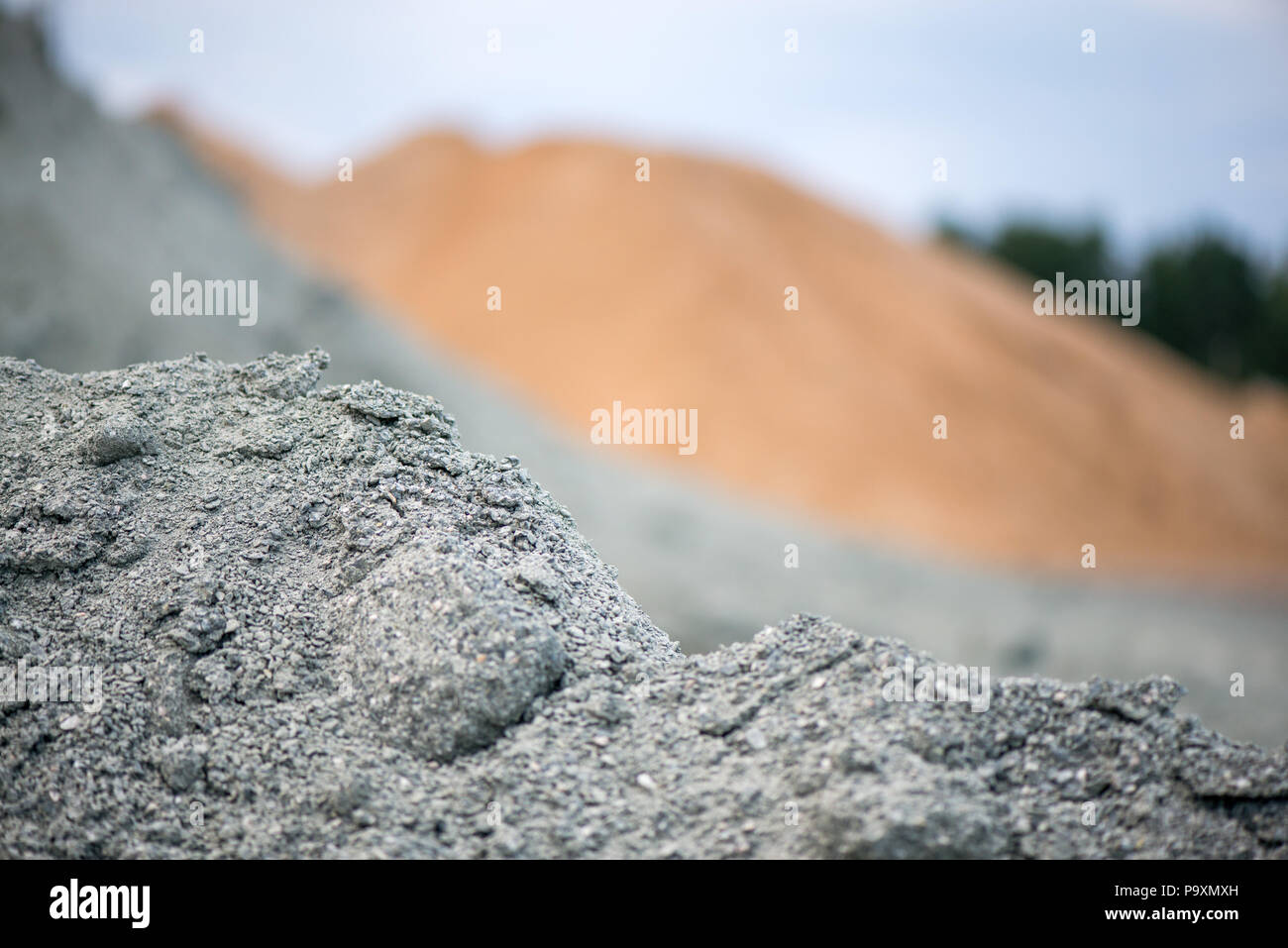 Large piles of construction sand and gravel used for asphalt production