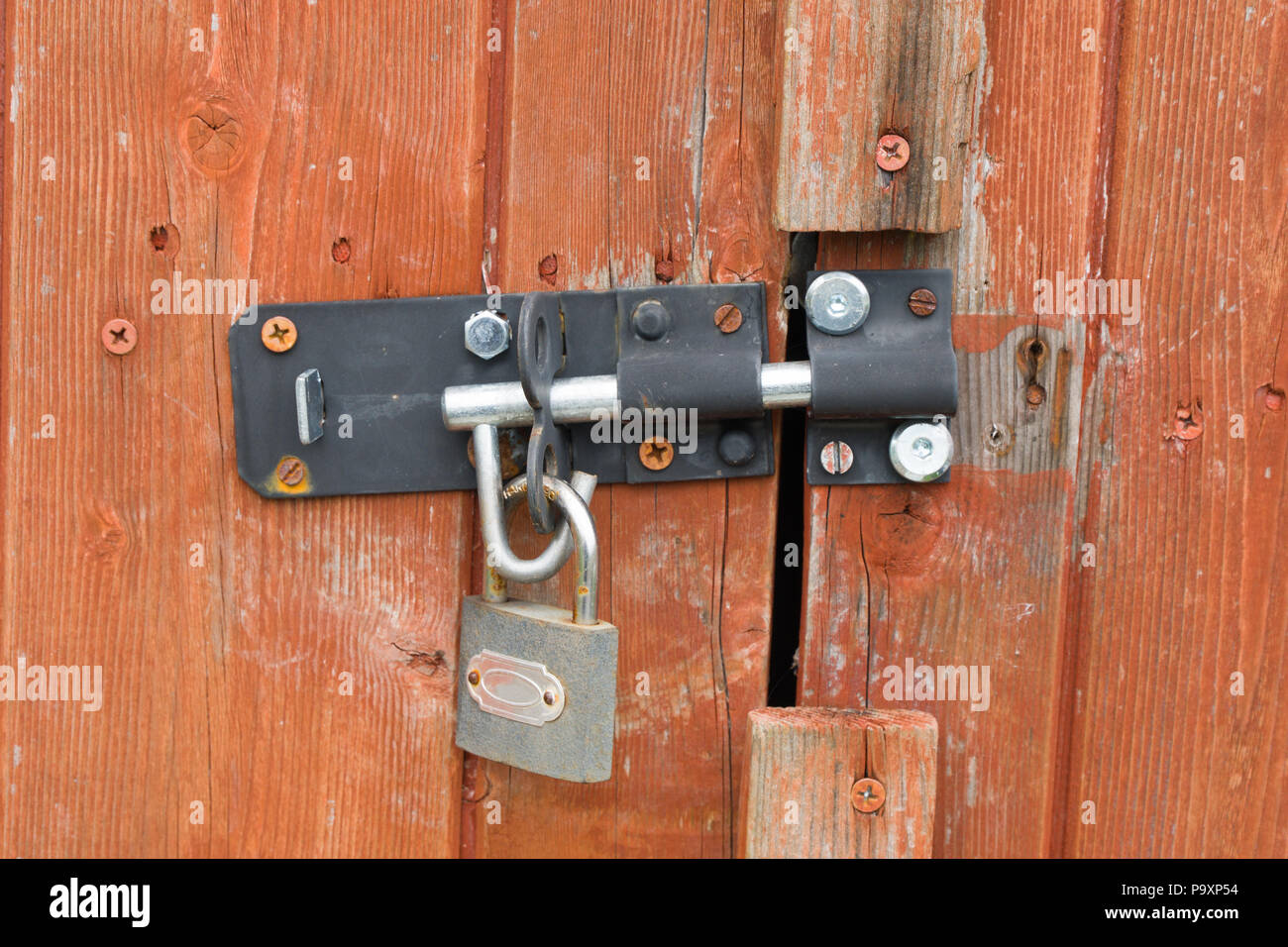 Padlock and hasp on a shed door Stock Photo Alamy