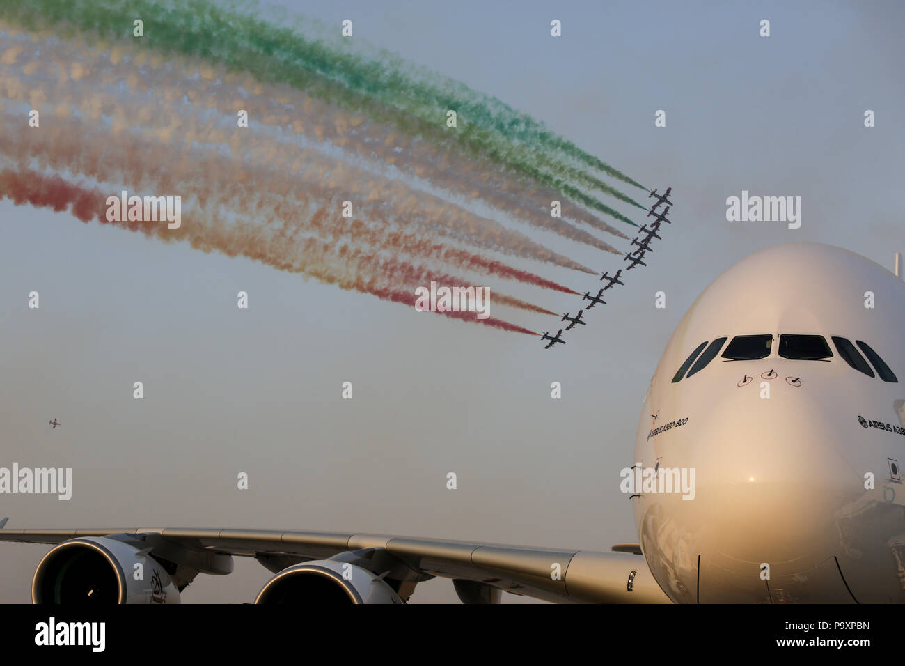 The Frecce Tricolori aerobatic team performs its demonstration flight over Airbus A380 airplane at Dubai International Airshow-2015, UAE Stock Photo