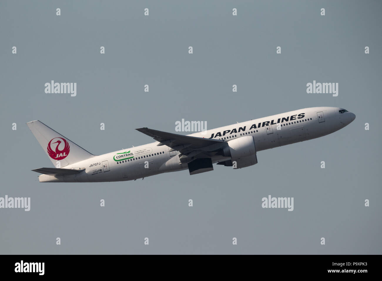 The Boeing 777-200 widebody civil jet airplane of JAL - Japan Airlines in the air after departing Hong Kong International Airport, China Stock Photo