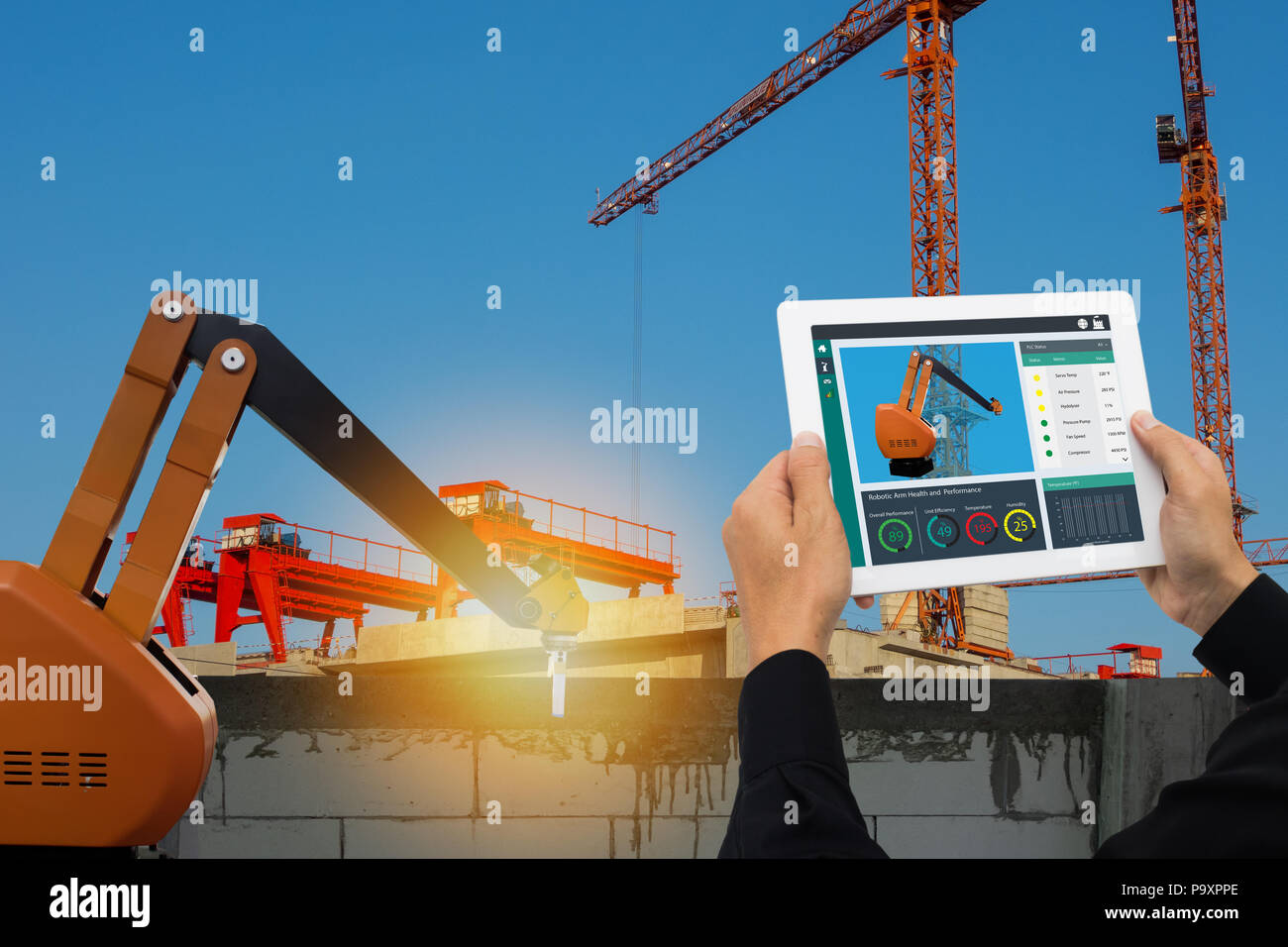 iot smart factory , industry 4.0 technology concept, Engineer use tablet to monitor, detect and analysis the robot arm for construction filed, Robot a Stock Photo