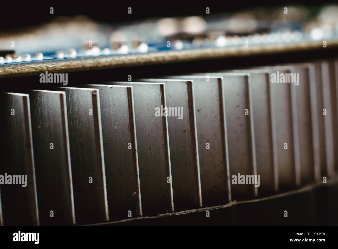 Dust on the computer pc processor cooler with mainboard and computer case fragment. Selective focus. Stock Photo