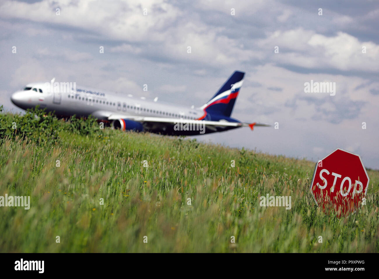 The Airbus A320 of Aeroflot Russian Airlines pictured in blur behind the STOP sign. Stock Photo