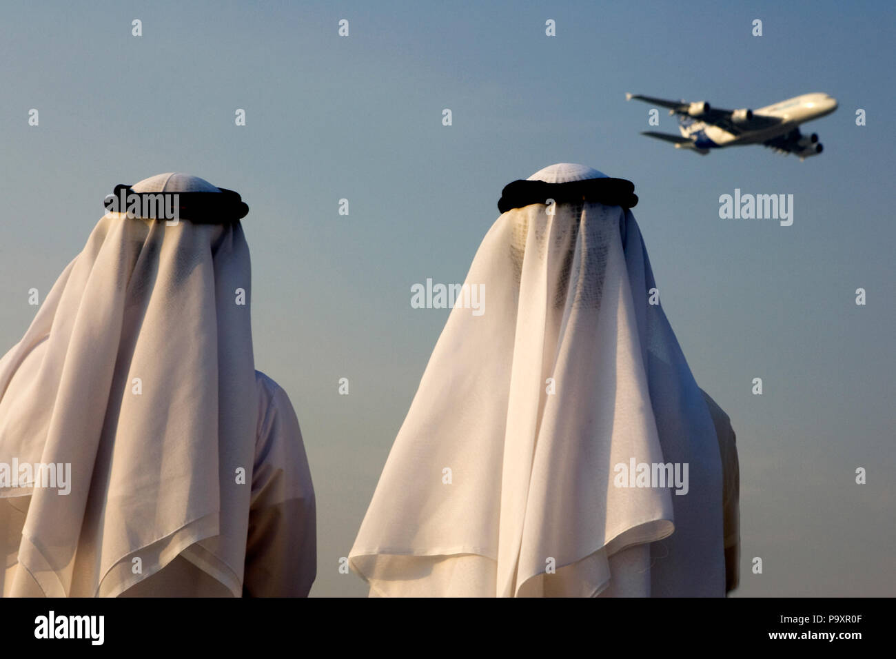 Visitors of Dubai Airshow-2009 watch the Airbus A380 civil jet aircraft, performing its demonstration flight over Dubai, UAE Stock Photo