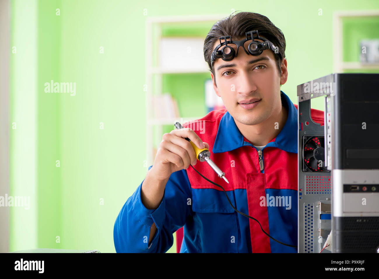 Computer engineer repairing broken desktop Stock Photo - Alamy