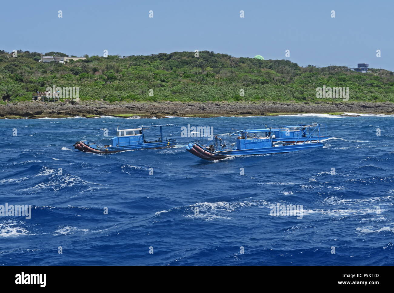 inshore fishing boats in rough sea southern Taiwan April Stock Photo
