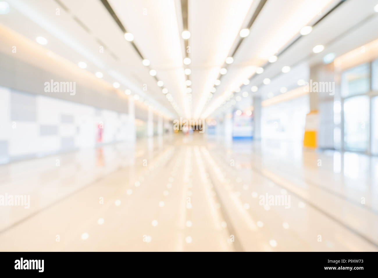 Blur, defocused bokeh background of exhibition hall or convention center hallway. Business trade show event, commercial tradeshow conference seminar Stock Photo