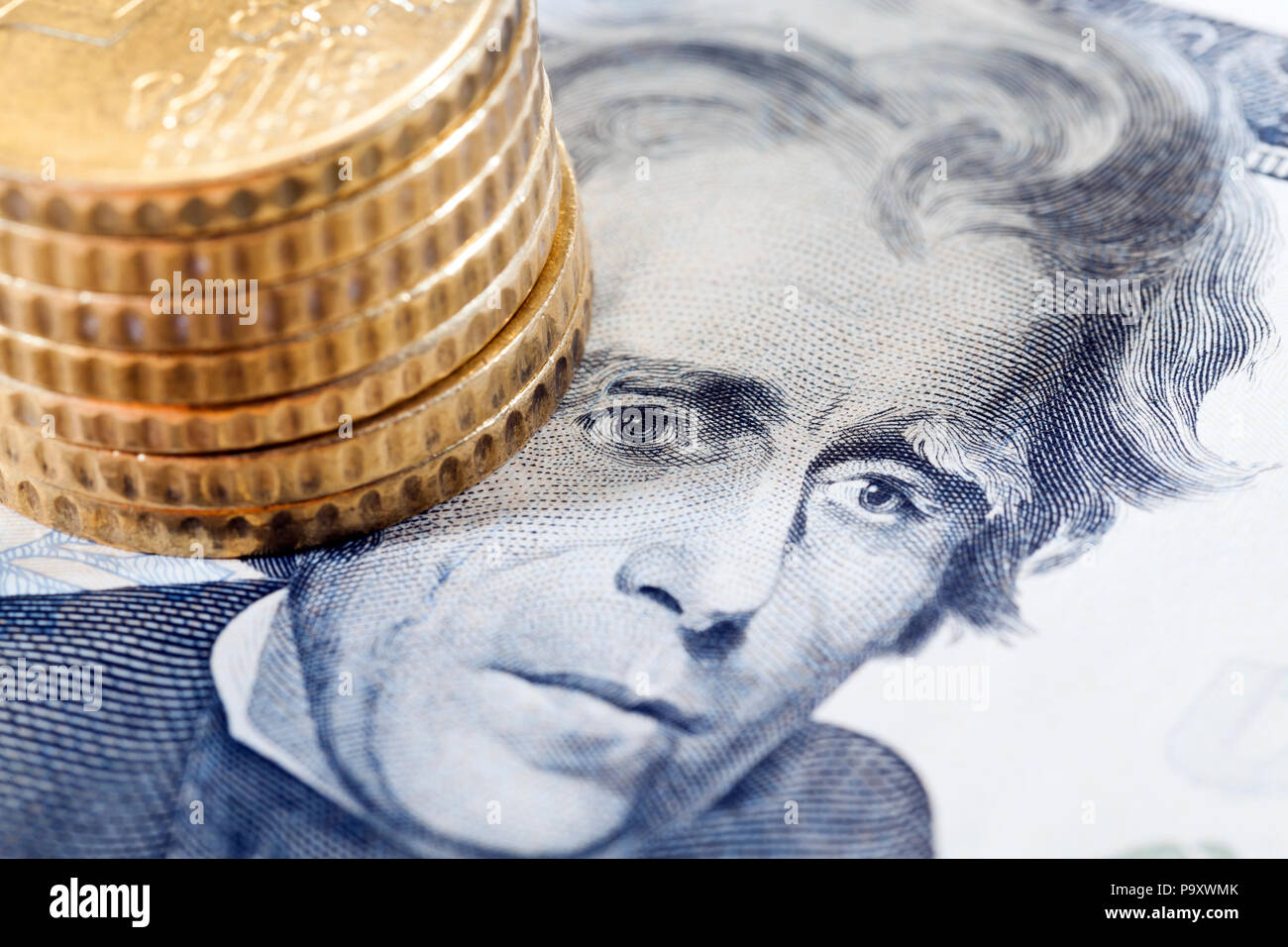 The obverse of the denominations of twenty American dollars and golden coins lying near the President portrait, a closeup photo Stock Photo