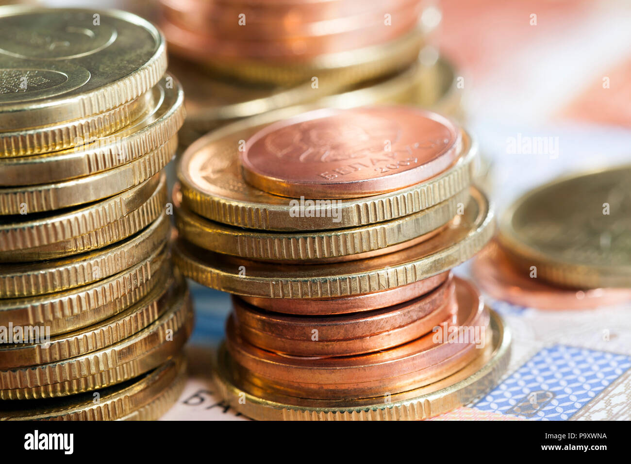 stack of coins of different colors and denominations lying together