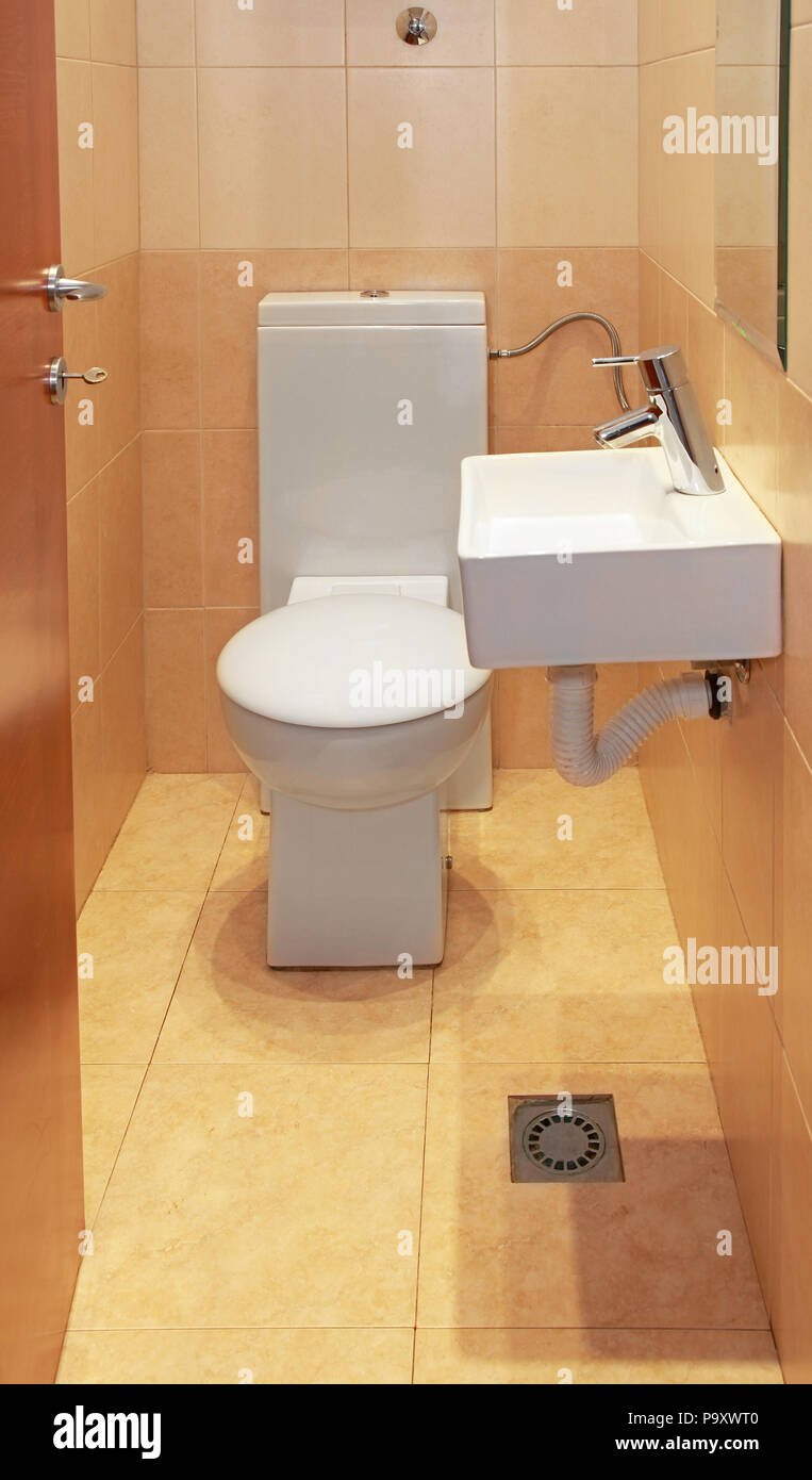 Small WC with toilet and wash sink Stock - Alamy