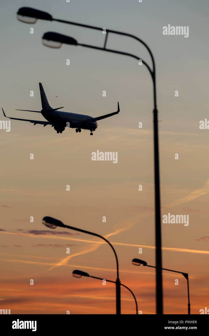 The Boeing 737-800 silhouettes against the sunrise sky as arriving at Sheremetyevo airport, Moscow Region, Russia Stock Photo