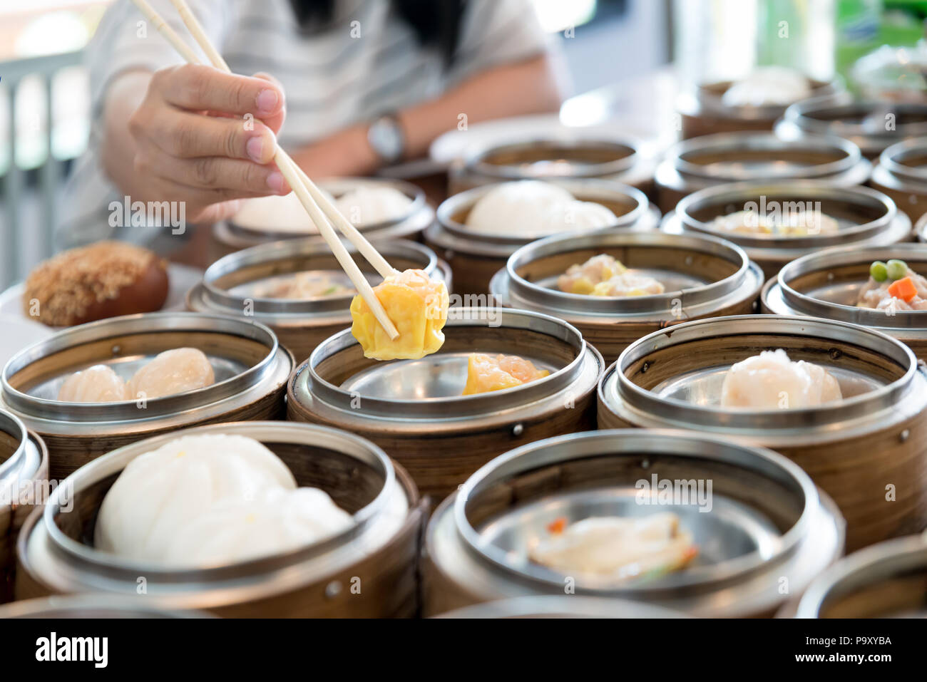 Chinese streamed dumpling in bamboo basket on table in Chinese restaurant. Stock Photo