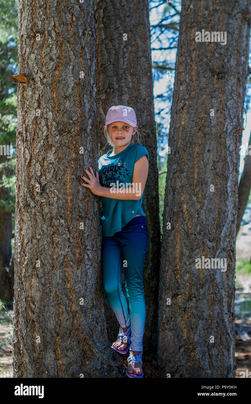 Beautiful Woman in a Special Outfit Climbing the Trees Stock Photo