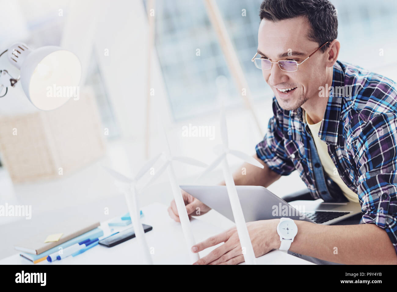 Delighted invalid keeping laptop on knees Stock Photo
