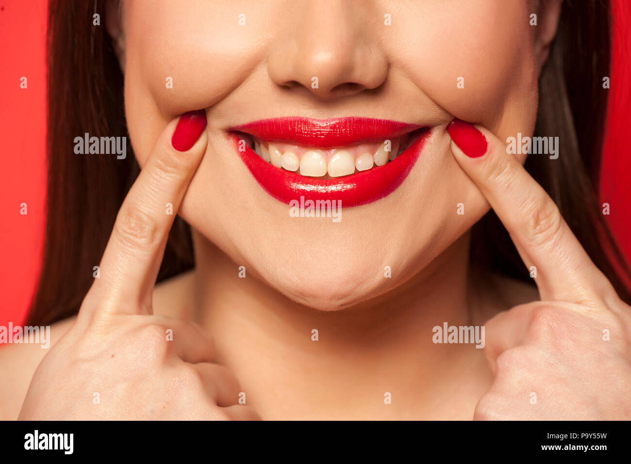woman forced her smile with her fingers Stock Photo