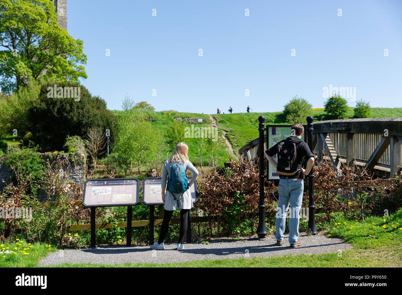 Trim, Ireland - tourists reading information board at the Trim Castle site overlooking river Boyne. Stock Photo