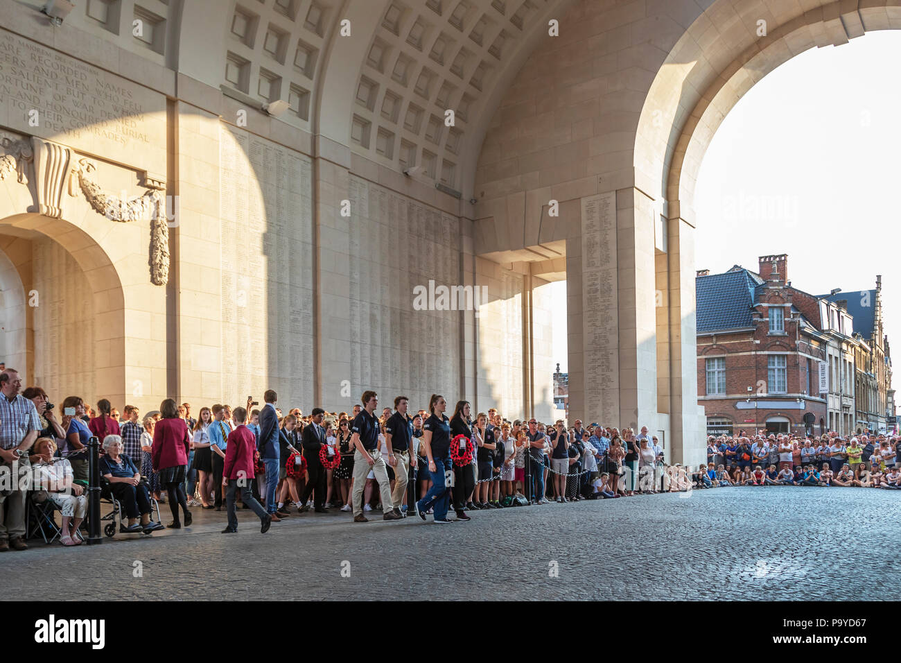 Schoolchildren laying a wreath of poppies at the Menin Gate war memorial during a service of remembrance, Ypres, Belgium Stock Photo