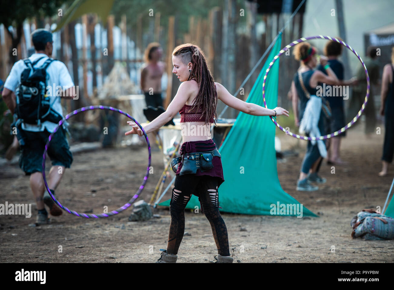 A young woman juggling with two hula hoops at the same time at the Lost  Theory psytransce music festival held in Riomalo de Abajo, Las Hurdes,  Extremadura, Spain Stock Photo - Alamy