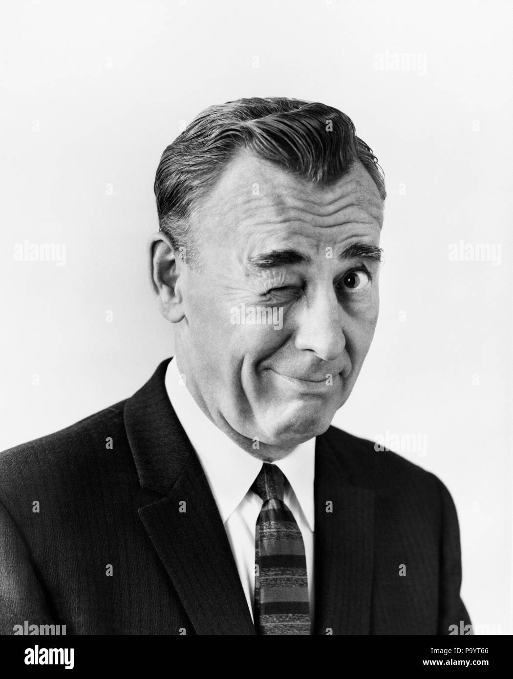 1950s portrait business man looking at camera winking his right eye bx018481 cam001 hars wise character confidence expressions middle aged b w winking middle aged man eye contact wink humorous selling head and shoulders