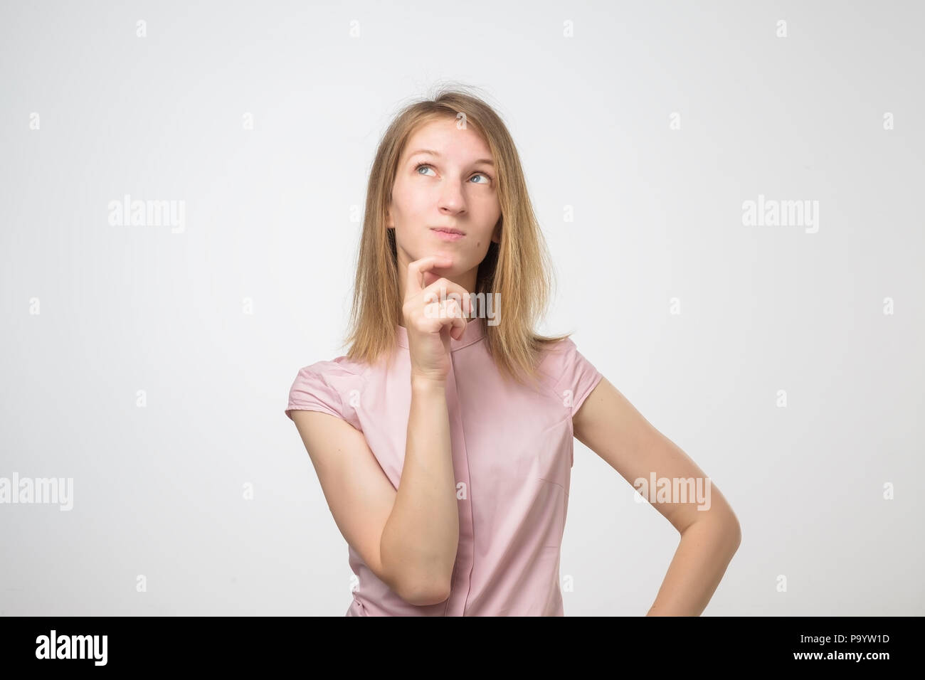 young pensive caucasian woman over white background Stock Photo