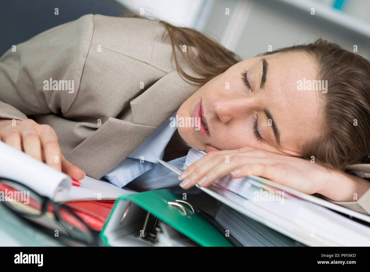 tired woman sleeping on books at her desk Stock Photo - Alamy