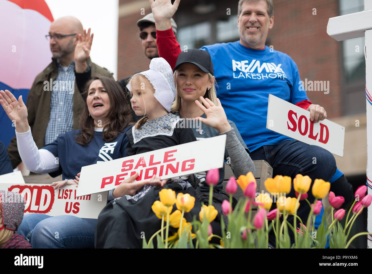 Holland, Michigan, USA - May 12, 2018 Float promoting Re/Max  with a hot air balloon and people holding signs that say, sold, sale pending at the Muzi Stock Photo