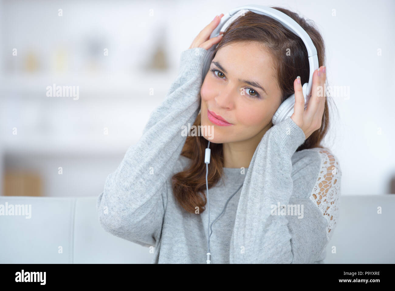 beautiful pregnant woman listening music on sofa Stock Photo - Alamy