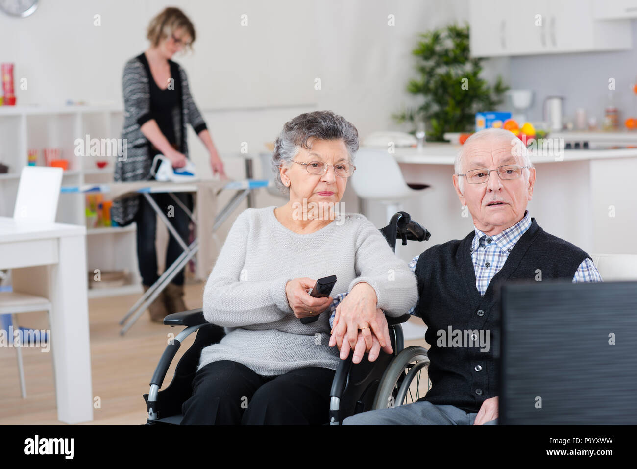 female volunteer is helping an old couple at home Stock Photo - Alamy