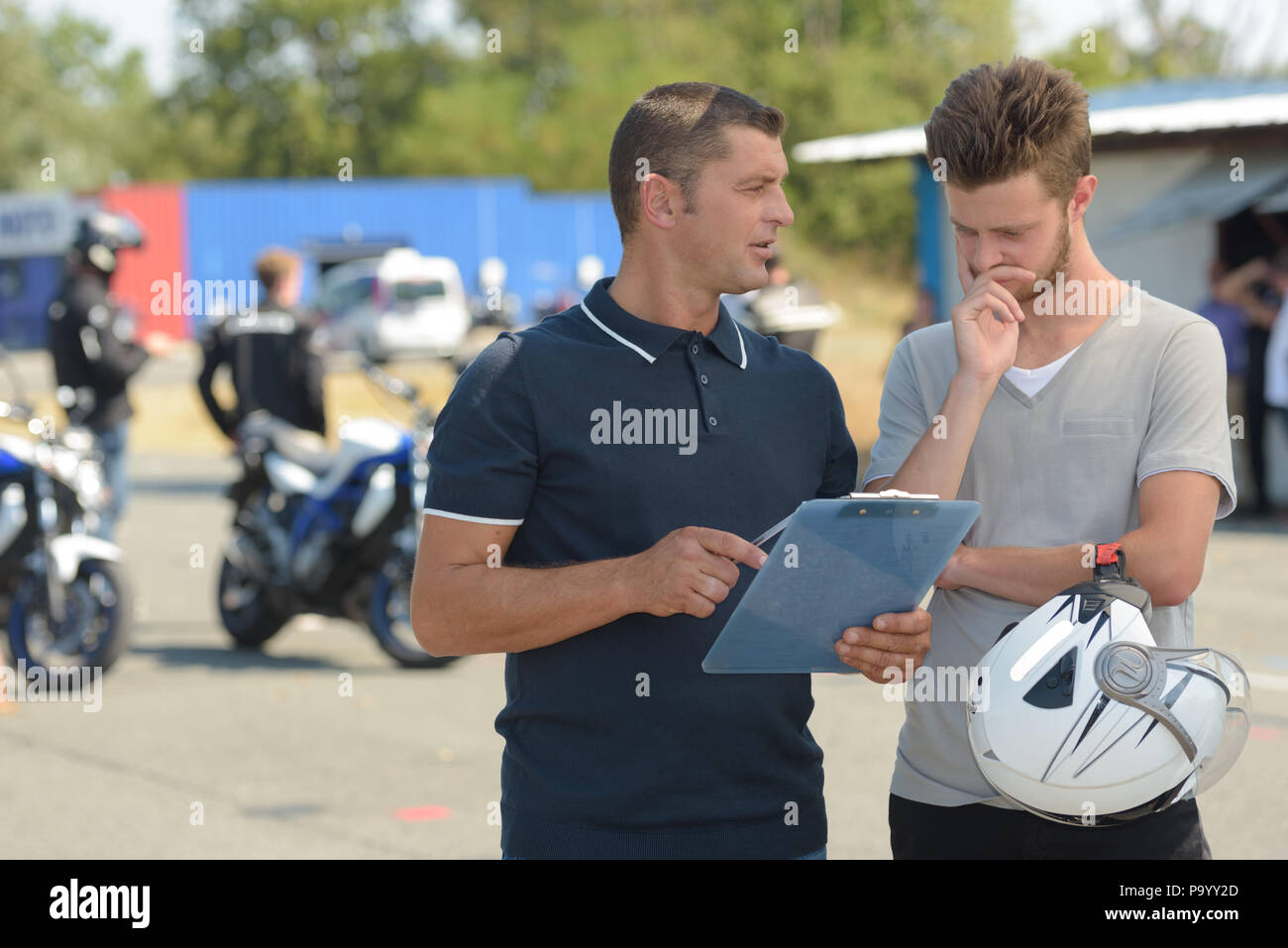 young man with instructor during motorbike lesson Stock Photo