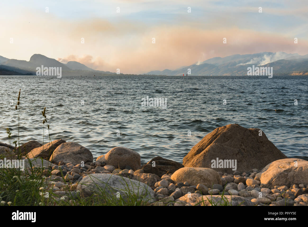 Forest fire smoke from multiple fires fills the sky over Okanagan Lake in the South Okanagan Stock Photo