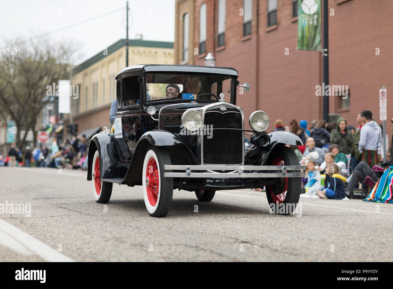Holland, Michigan, USA - May 12, 2018 Old Classic Ford car going down the road at the Muziek Parade, during the Tulip Time Festival Stock Photo