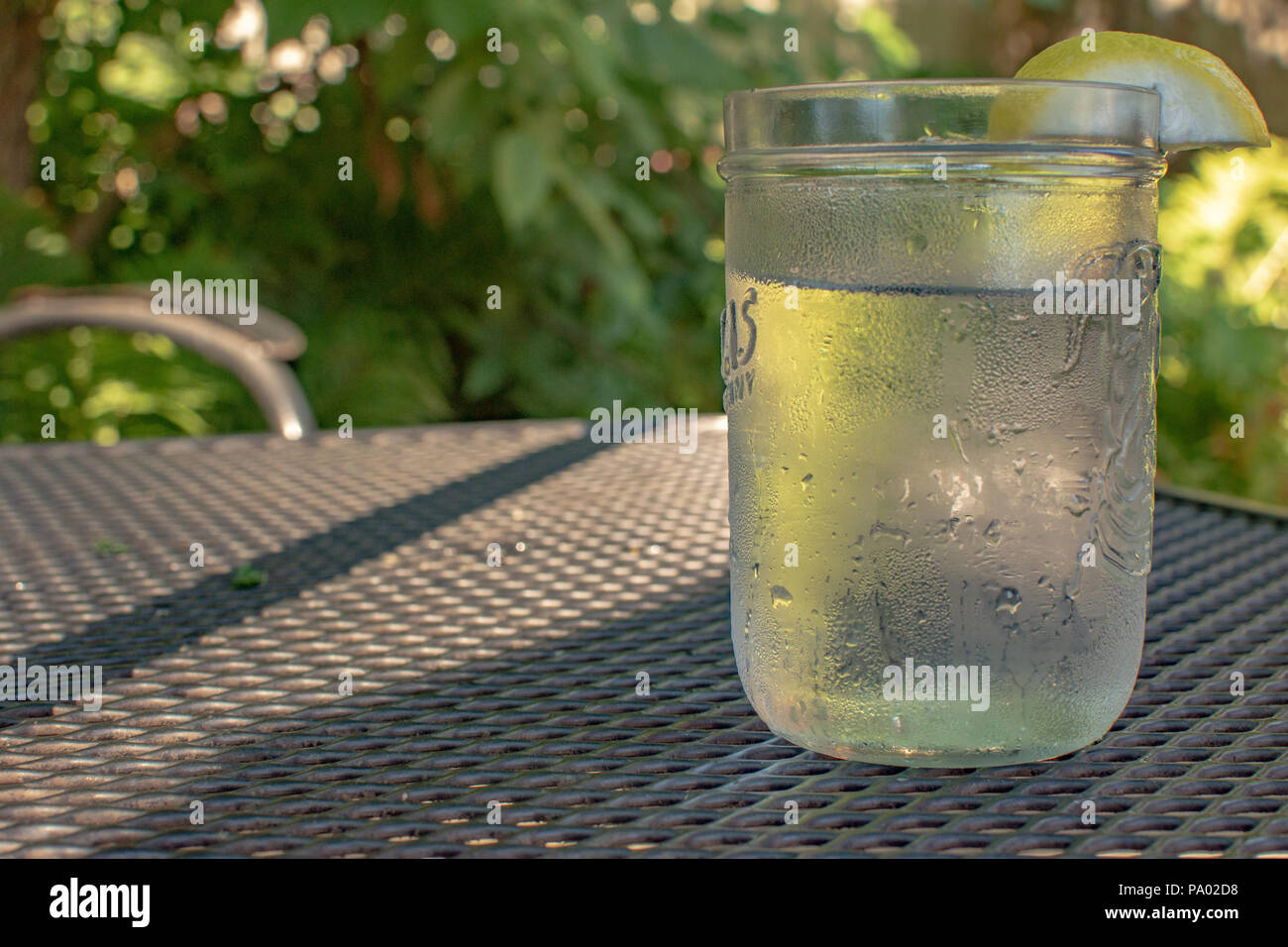 Glass of water with lemon wedge Stock Photo