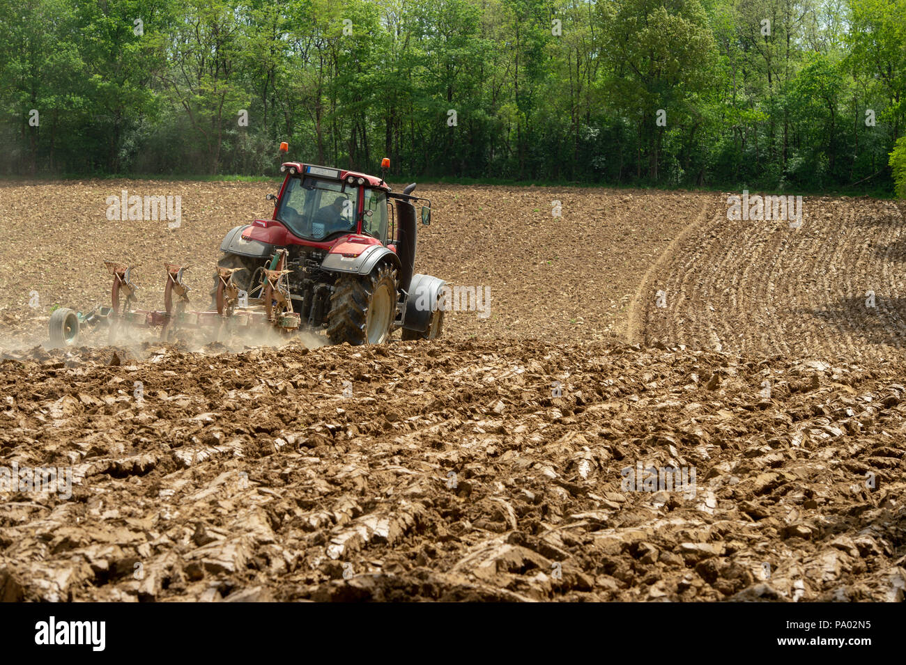 Farmer on tractor plow field, France, Europe Stock Photo - Alamy