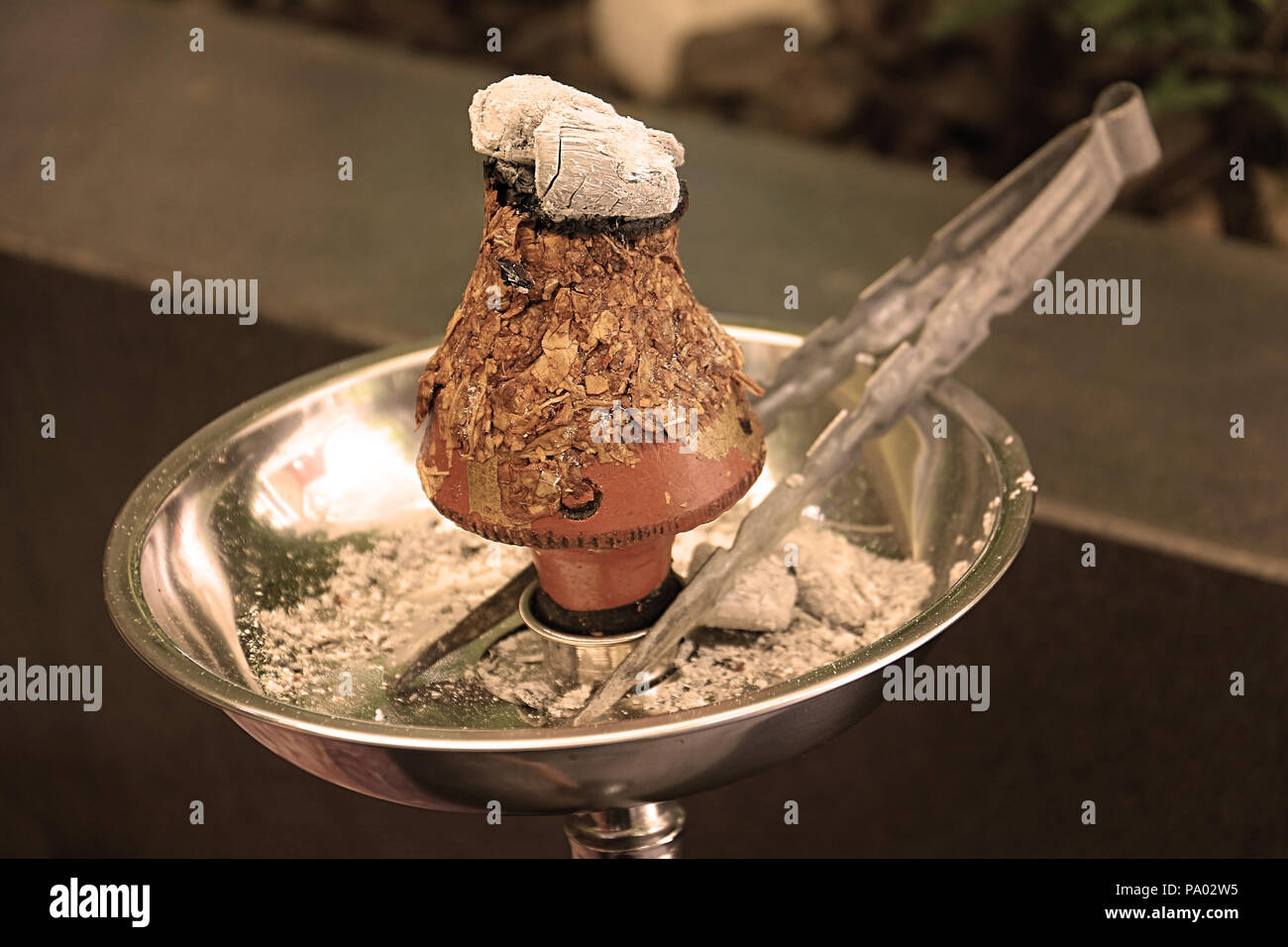 Ajami tobacco leaves burning in a hookah head, vintage colors Stock Photo -  Alamy