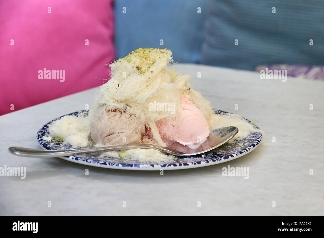 Ice cream covered with  traditional Lebanese cotton candy and pistachios. Stock Photo