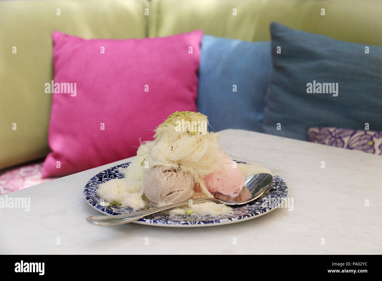 Ice cream covered with traditional Lebanese cotton candy and pistachios. Stock Photo