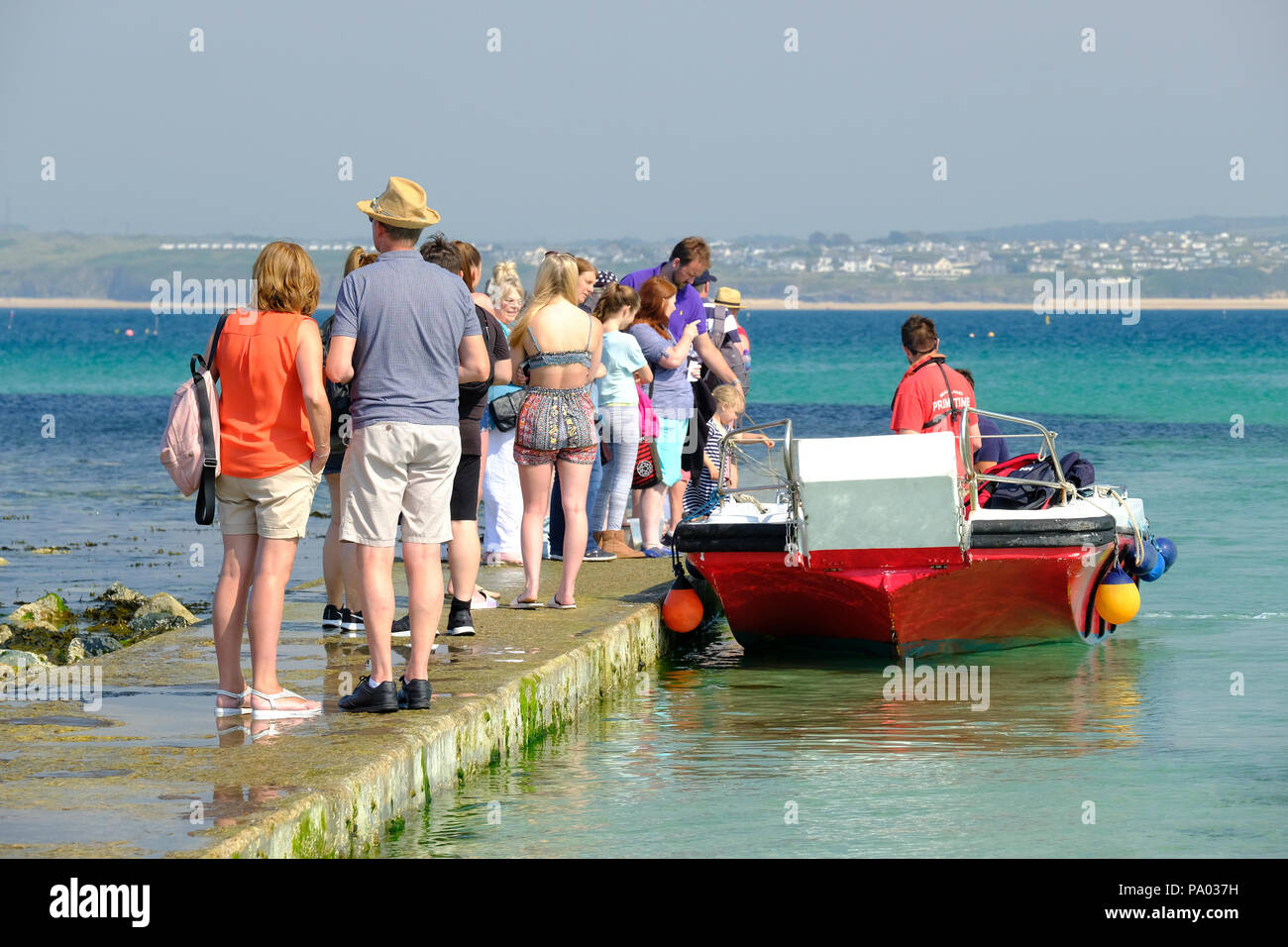 Queue of people waiting for a boat trip at St Ives in Cornwall Stock Photo