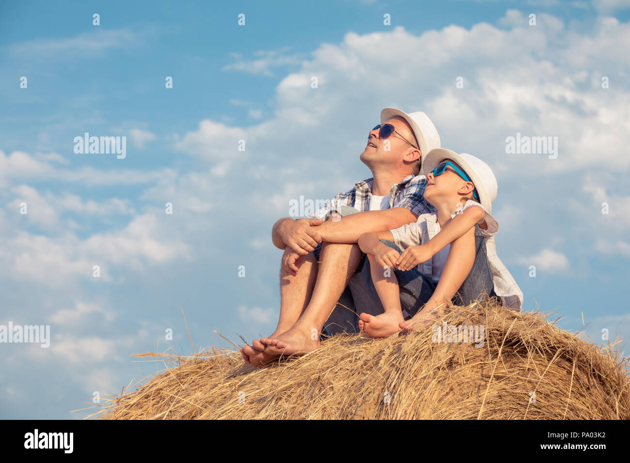 Father and son playing in the park at the day time. People having fun outdoors. Concept of summer vacation and friendly family. Stock Photo