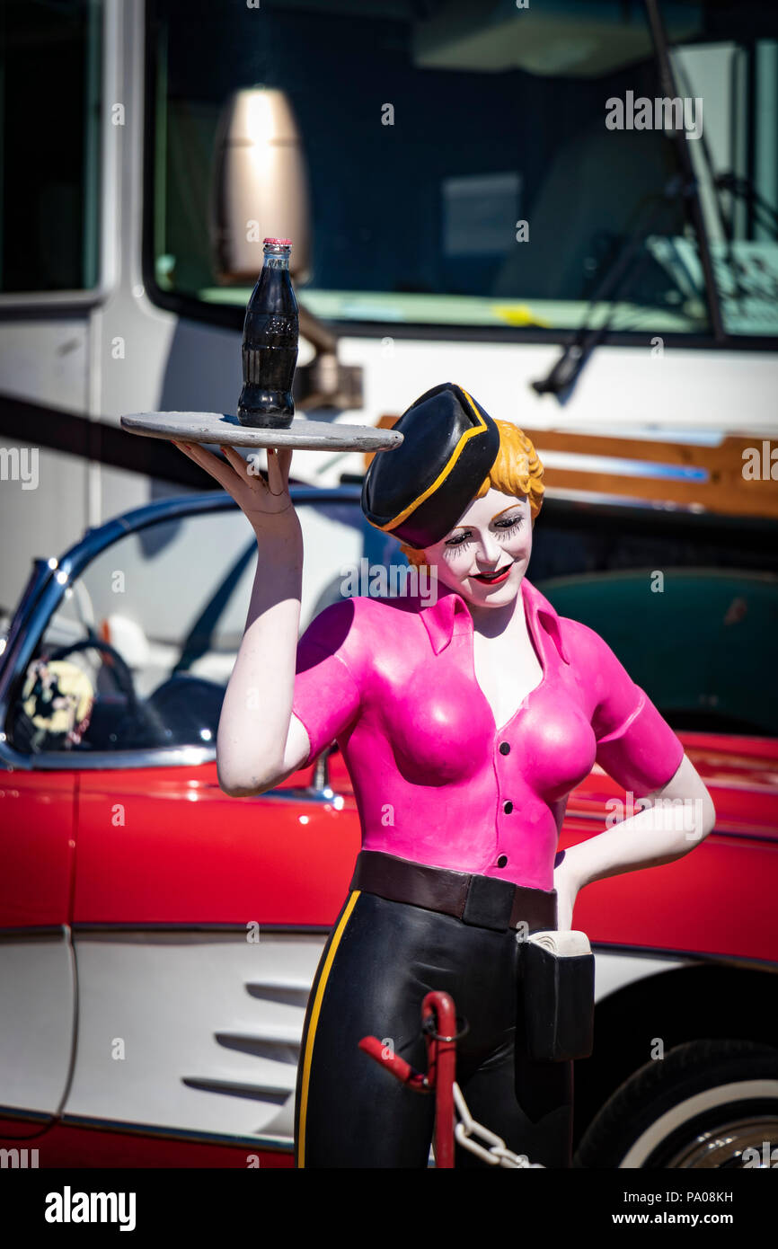 vintage mannequin of female fast food barhop server on roller skates at with coke on a tray at Stars & Stripes classic American car show Stock Photo