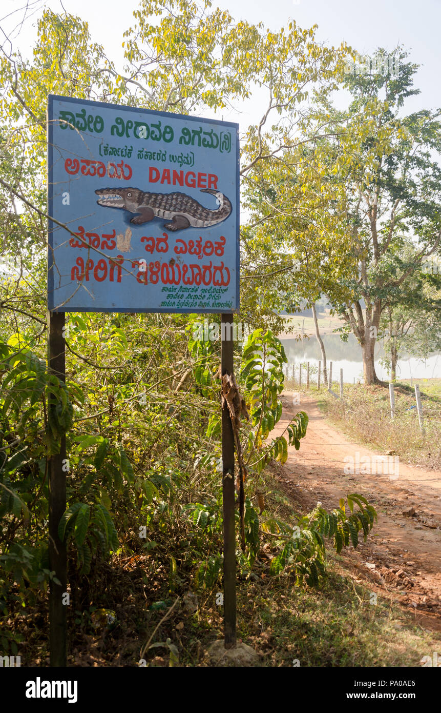 Crocodile warning signboards at Chiklihole Reservoir in Kushalnagar, Kodagu, Karnataka, India Stock Photo