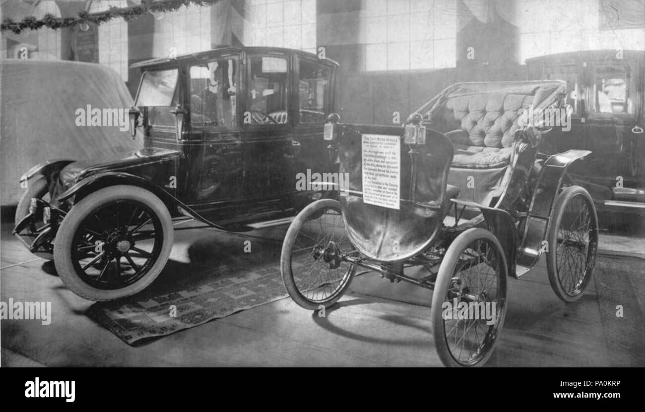 613 Electric car and antique car on display at 1912 auto show Stock Photo