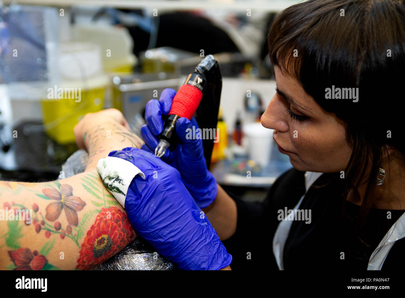 Tattoo artist applying a tattoo hi-res stock photography and images