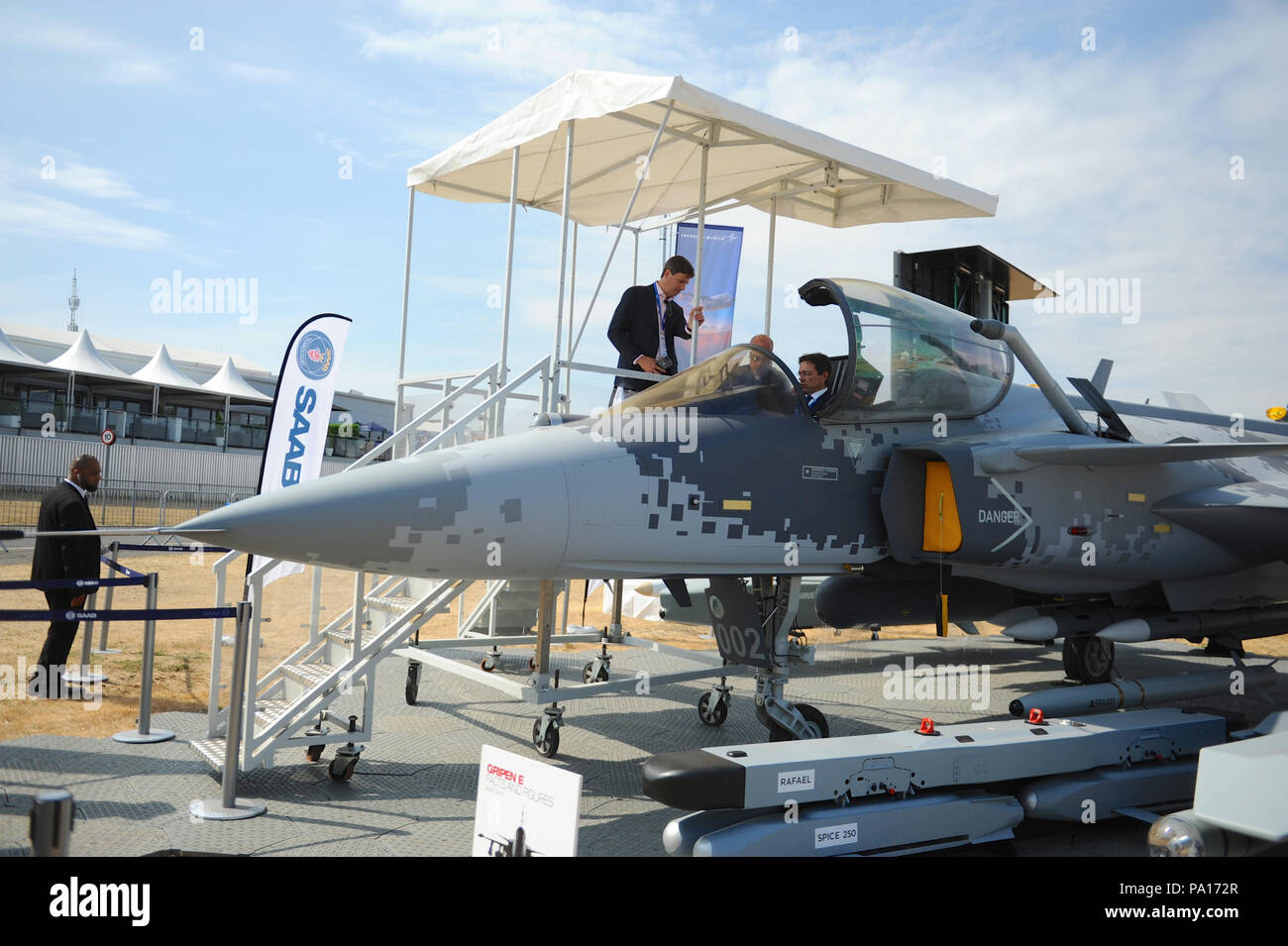 farnborough-hampshire-uk-19th-july-2018-buyers-sitting-in-the-cockpit-of-a-full-scale-mock-up-of-a-saab-jas-39-gripen-light-single-engine-multirole-fighter-aircraft-on-day-four-of-the-farnborough-international-airshow-fia-which-is-taking-place-in-farnborough-hampshire-uk-the-air-show-a-biannual-showcase-for-the-aviation-industry-is-the-biggest-of-its-kind-and-attracts-civil-and-military-buyers-from-all-over-the-world-trade-visitors-are-normally-in-excess-of-100000-people-credit-michael-prestonalamy-live-news-PA172R.jpg