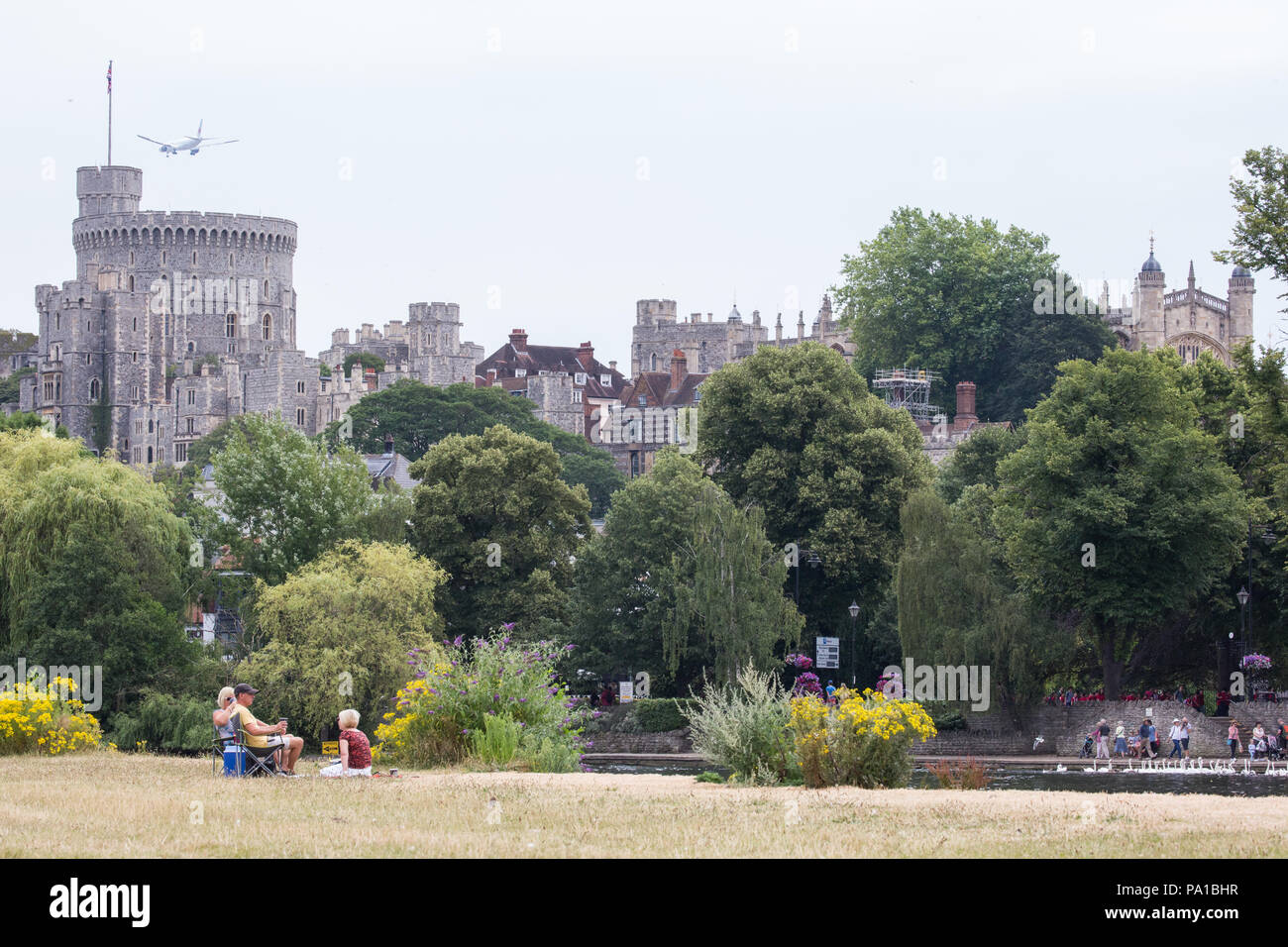 Windsor, UK. 20th July, 2018. Yellowed grass at the Brocas in Eton with Windsor Castle behind following the UK's longest heatwave for more than forty years. The grass around Windsor Castle was a lush green at the time of the wedding of the Duke and Duchess of Sussex in May. Credit: Mark Kerrison/Alamy Live News Stock Photo