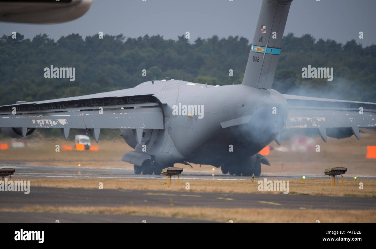 Farnborough, Hampshire, UK. 20 July, 2018. Final day of the biennial Farnborough International Trade Airshow FIA2018, typically a transition day as business customers leave in VIP jets and members of the public arrive to watch the build-up for the weekend public airshow. A large Boeing C-17 Globemaster III military transport aircraft of the US Air Force arrives and parks up. It will display during the public weekend. Credit: Malcolm Park/Alamy Live News. Stock Photo