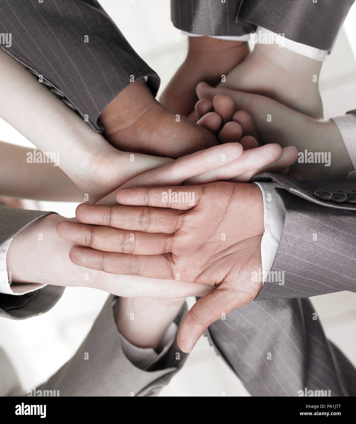 closeup.international business team showing their unity Stock Photo - Alamy