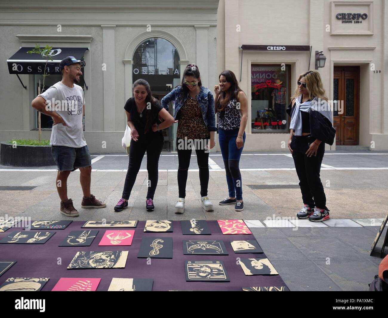 Cordoba, Argentina - 2018: An artist sells paintings on the street to tourist in the downtown district. Stock Photo
